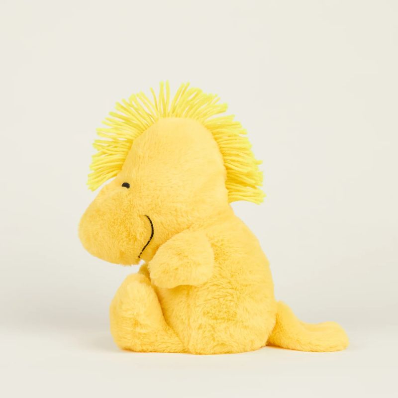 A plush toy resembling a yellow woodstock with a crown, designed to be heatable and scented with lavender.