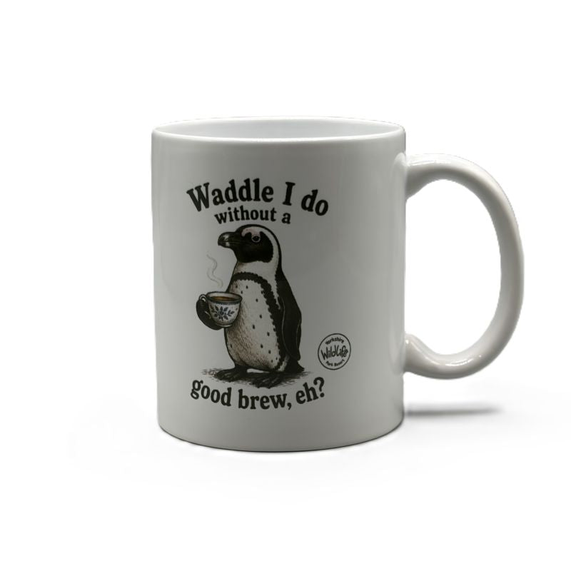 A white ceramic mug featuring a black and white illustration of a penguin holding a tea cup, with the text 'Waddle I do without a good brew, eh?' printed on the front and yorkshire wildlife park logo