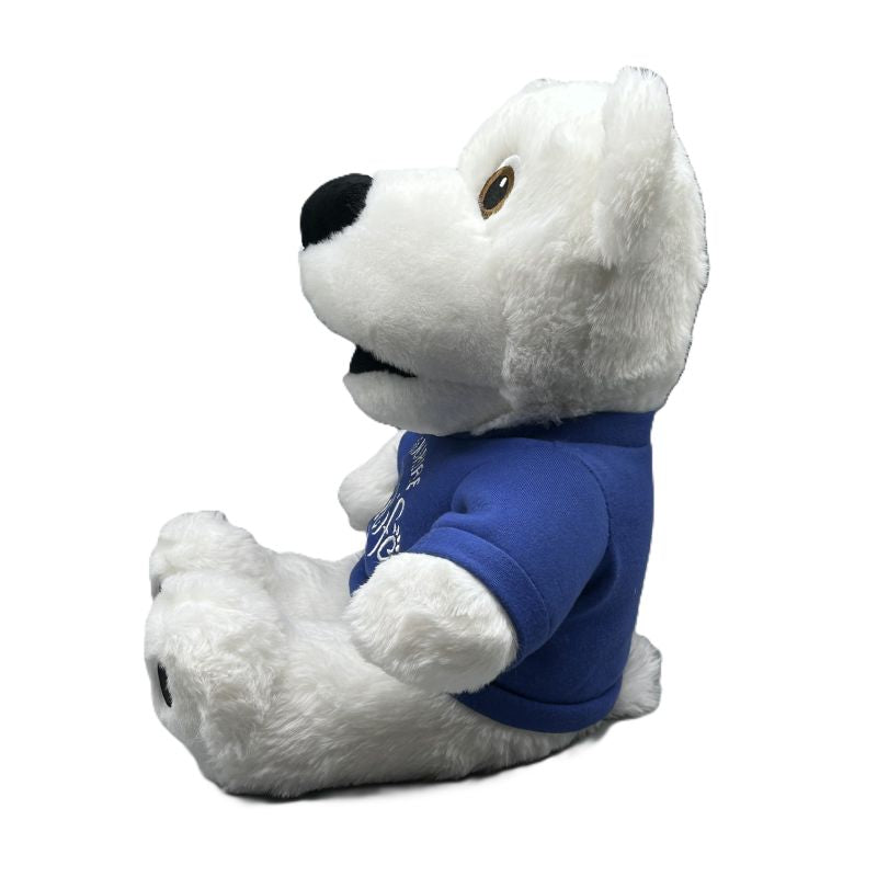 White plush polar bear toy wearing a blue shirt on a white background