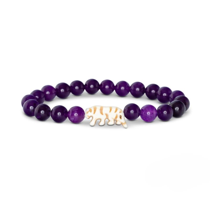 Purple beaded bracelet with a white tiger charm on a white background