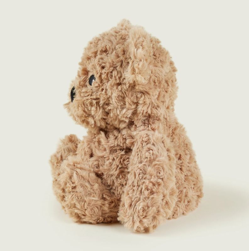 A brown, plush teddy bear with curly fur and a Microwaveable feature.