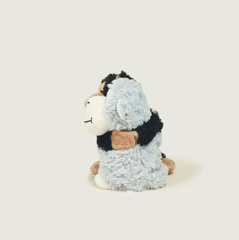 A set of two plush monkey toys in black and grey colours, packaged in a box, designed to be heated in a microwave for warmth.