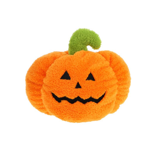 Plush pumpkin toy with a smiling face on a white background