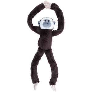 Plush gibbon monkey toy hanging on a white background