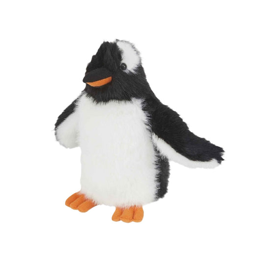 A plush toy gentoo penguin with black and white fur, an orange beak, and orange feet, standing against a plain white background.