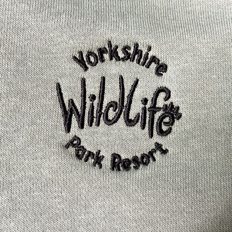 Embroidered Yorkshire Wildlife Park Resort logo on a green fabric background