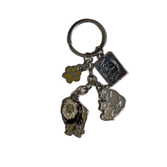 Keychain with lion, lioness with cub, and paw print charms on a white background