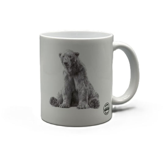 A white ceramic mug featuring a black and white graphic print of Victor the polar bear sitting down, with a small circular yorkshire wildlife park logo on the lower right side of the mug, set against a plain white background.