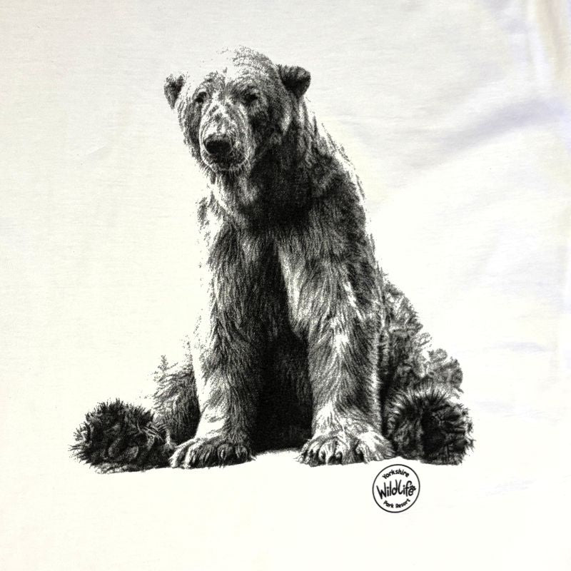 A black and white sketch-style print of a bear sitting on a white fabric background, with a small circular 'Wildlife' logo near the lower right of the bear.