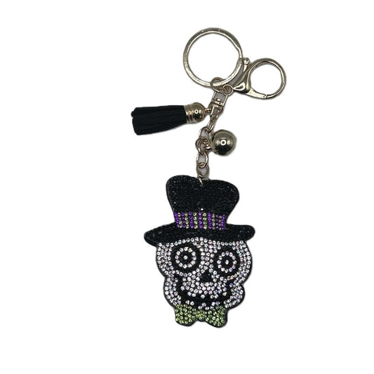 Sparkly keychain with skull design  wearing a top hat on a white background