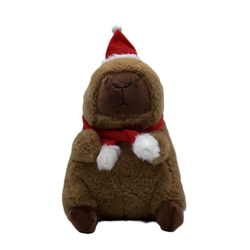 Plush toy capybara wearing a Santa hat and scarf on a white background