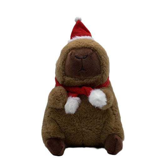 Plush toy capybara wearing a Santa hat and scarf on a white background