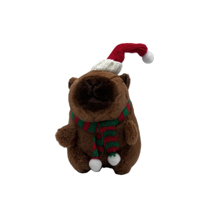 Plush toy capybara wearing a Santa hat and scarf on a white background