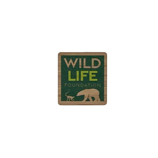 Bamboo pin badge with logo of the Wild Life Foundation with a polar bear silhouette on a green background