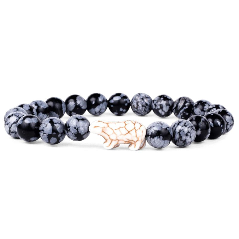 A bracelet with black grey beads and a prominent polar bear charm for tracking polar bears.