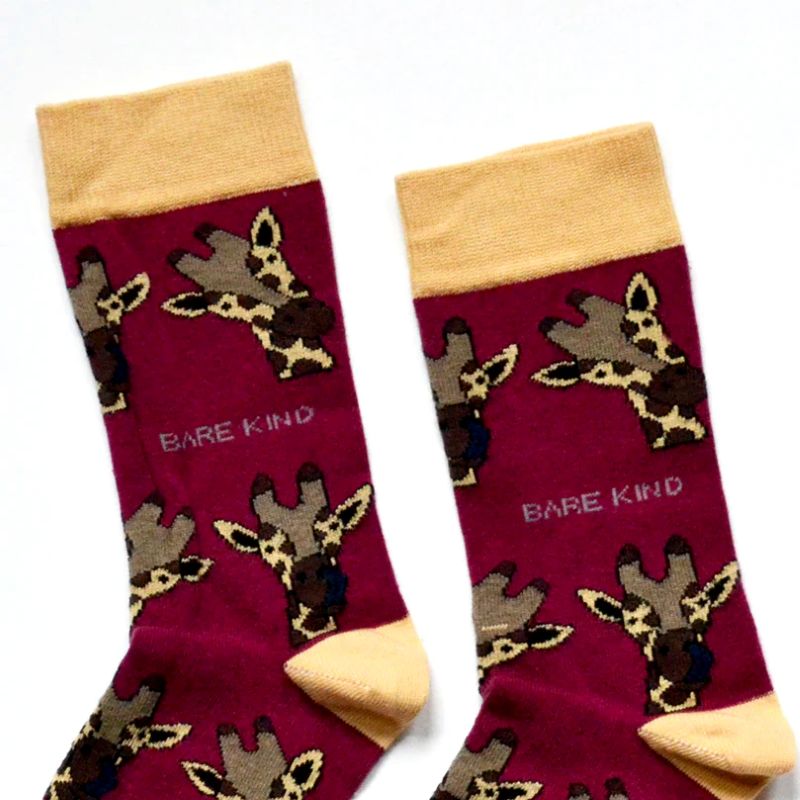 Pair of socks with giraffe pattern and 'Bare Kind' branding on a white background