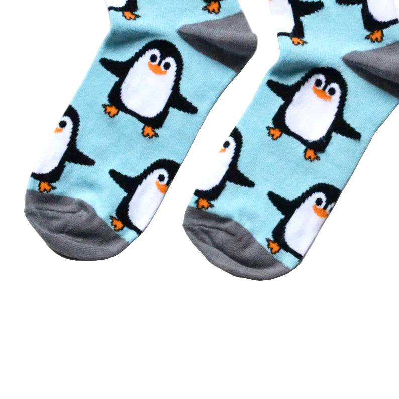 Pair of socks with penguin pattern on a light blue background