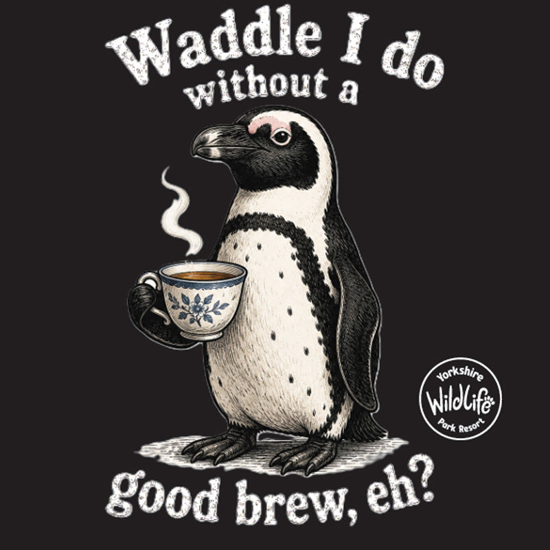 A black graphic print featuring a penguin holding a steaming cup of tea, with the text 'Waddle I do without a good brew, eh?' and a circular 'Yorkshire Wildlife Park Rescue' logo.