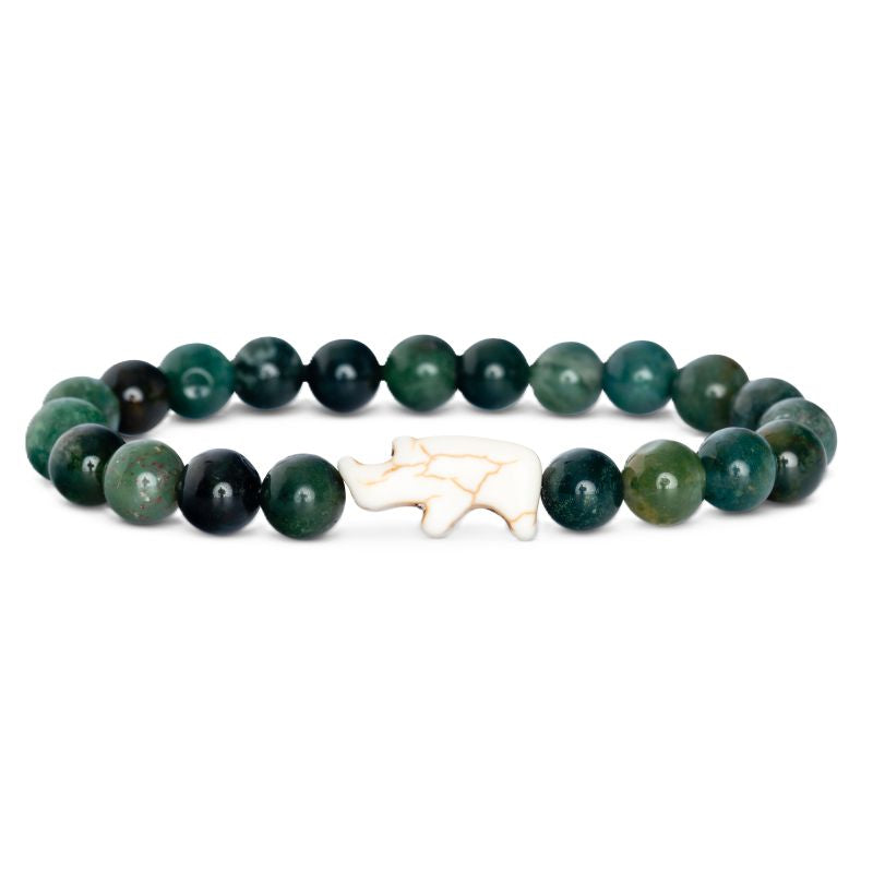 Green beaded bracelet with a white rhino charm on a white background