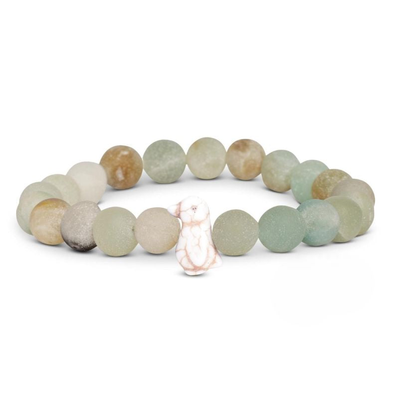 Pastel multicolored beaded fahlo bracelet with a penguin charm on a white background