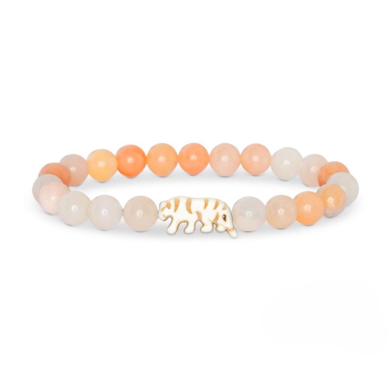 Beaded bracelet with peach and white stones and a tiger charm on a white background