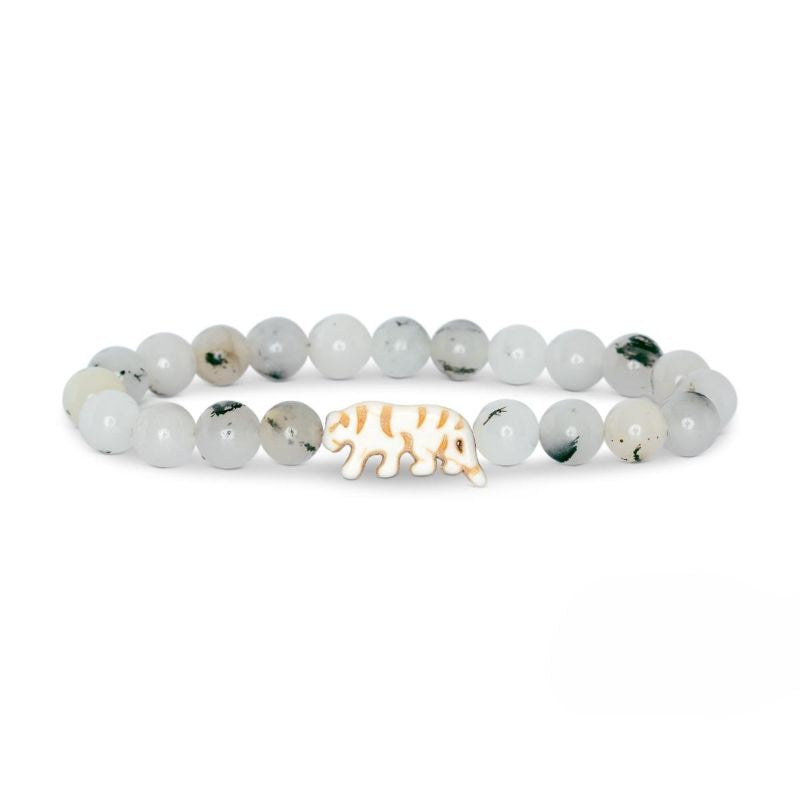 Bracelet with white beads and a gold tiger charm on a white background