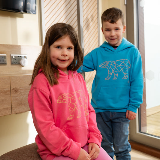 boy and girl wearing yorkshire wildlife park geometric polar bear kids hoodie with geometric polar bear design