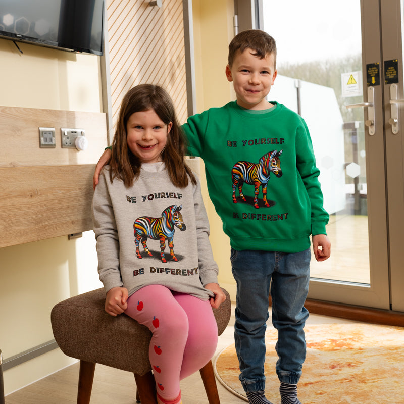 yorkshire wildlife park kids be yourself be different girl and boy wearing grey and green sweat shirt with rainbow coloured giraffe