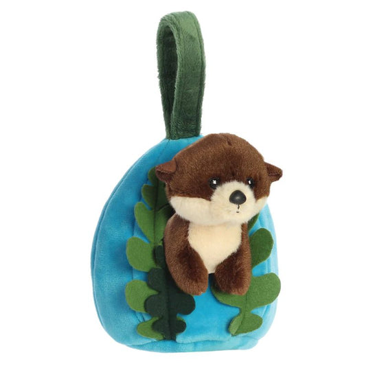 Plush toy otter in a blue pouch with green leaves on a white background