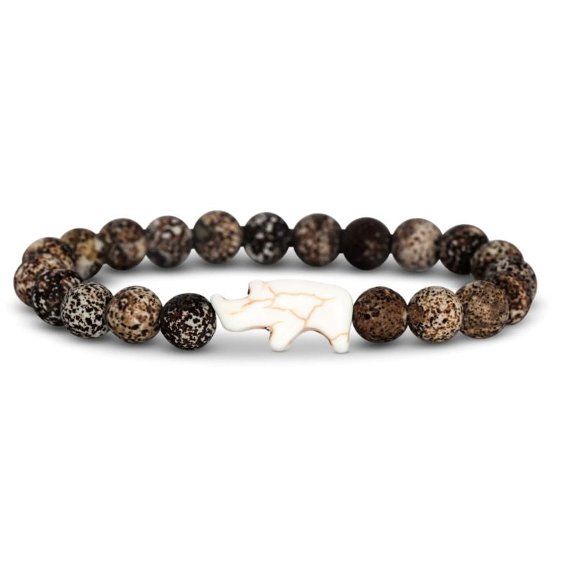 Bracelet with brown beads and a white rhino charm on a white background